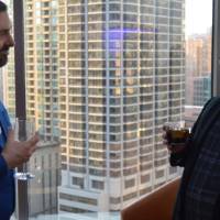 Two alumni enjoy a conversation with one another